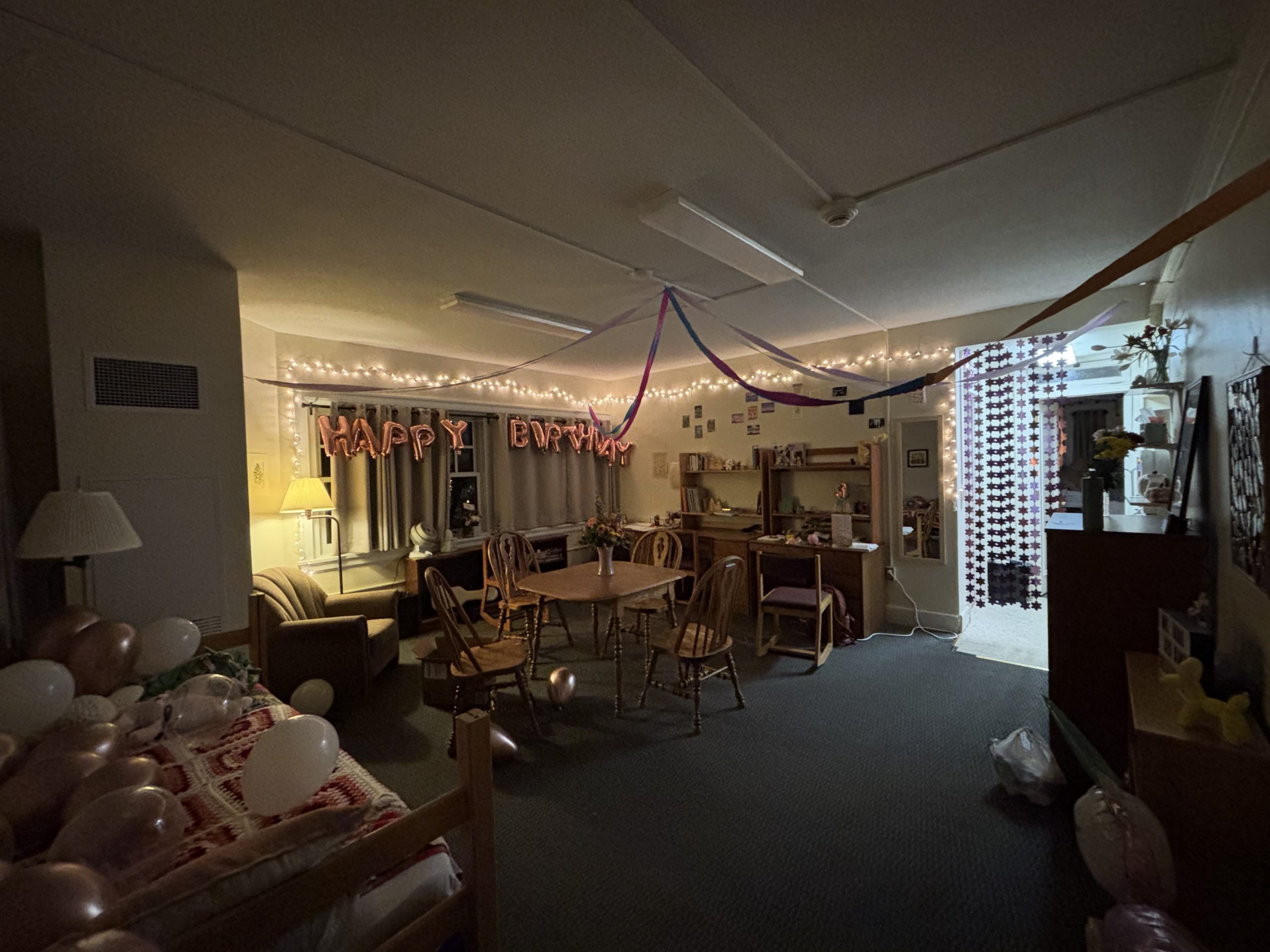A room with streamers and balloons set up