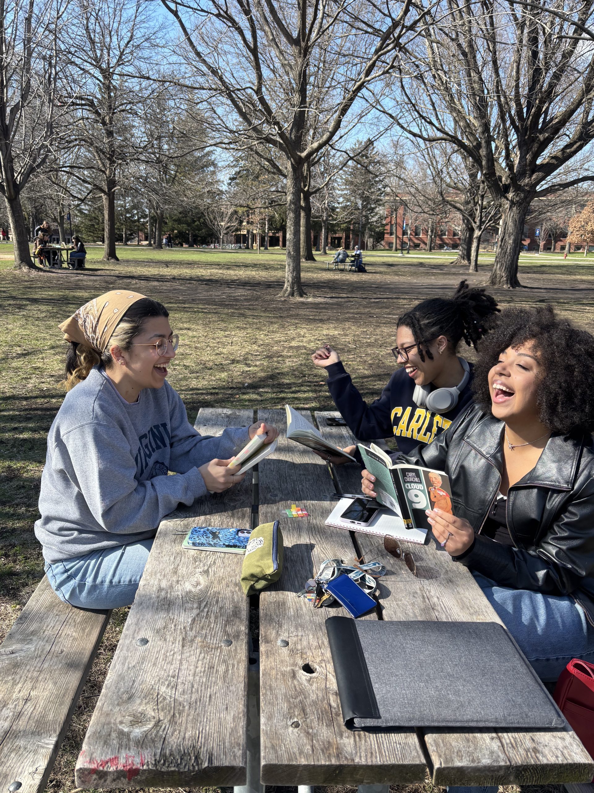 Three students outside on a sunny day