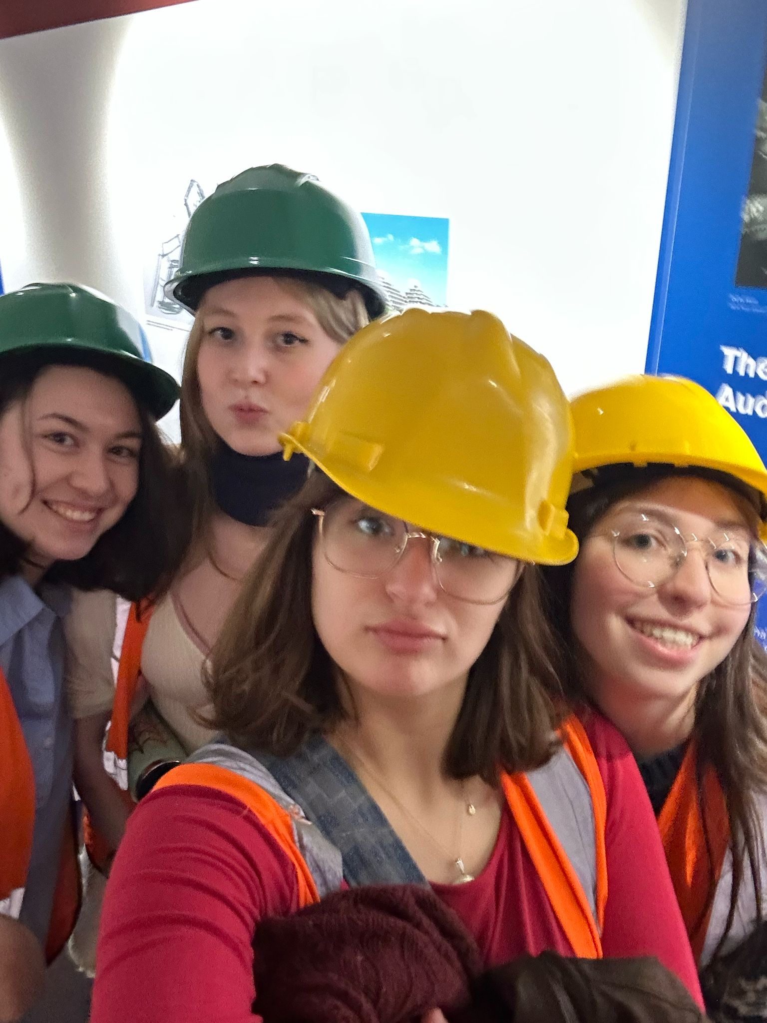 Four girls in hard hats smiling