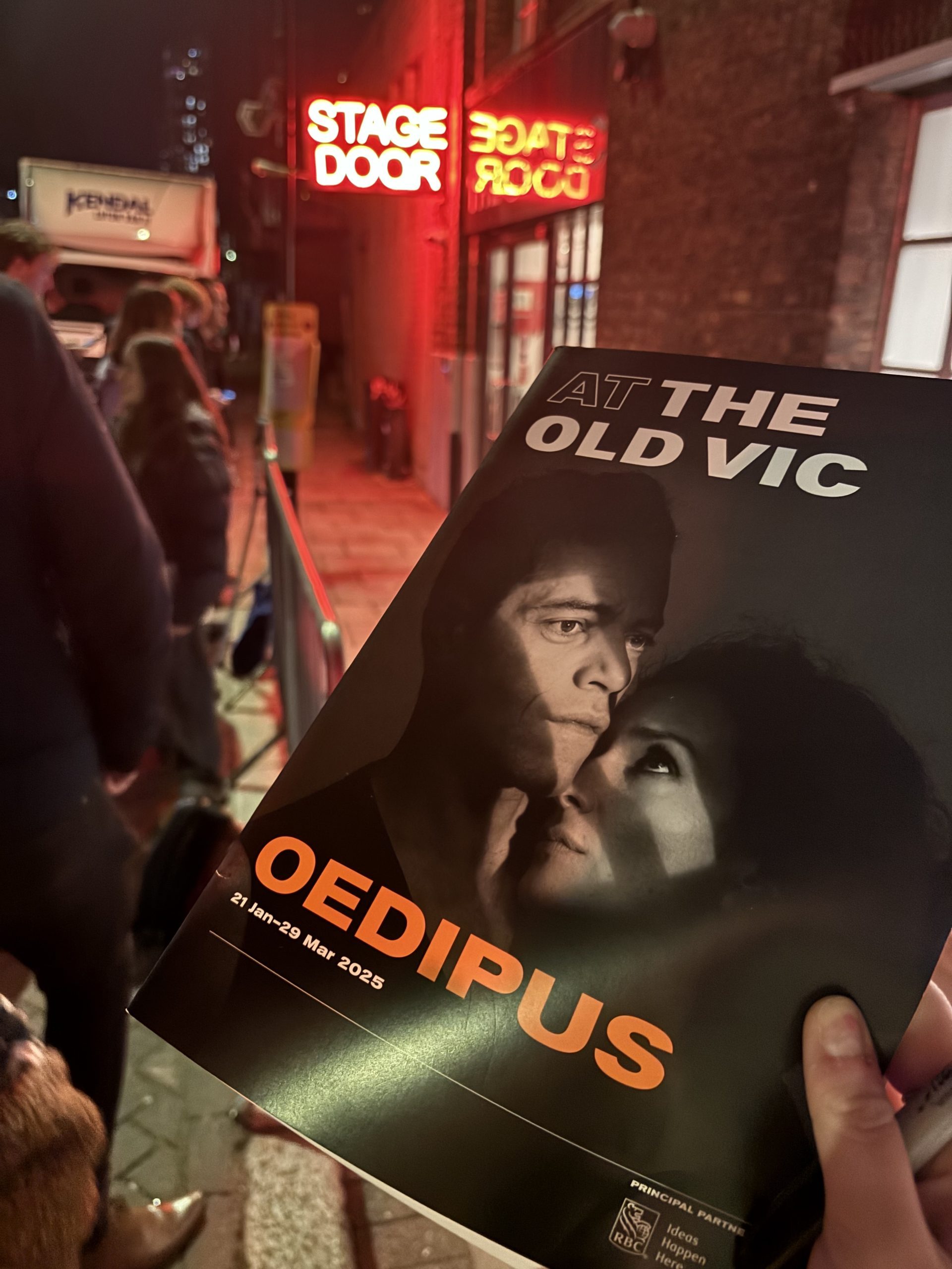 A program for Oedipus in front of a stage door sign