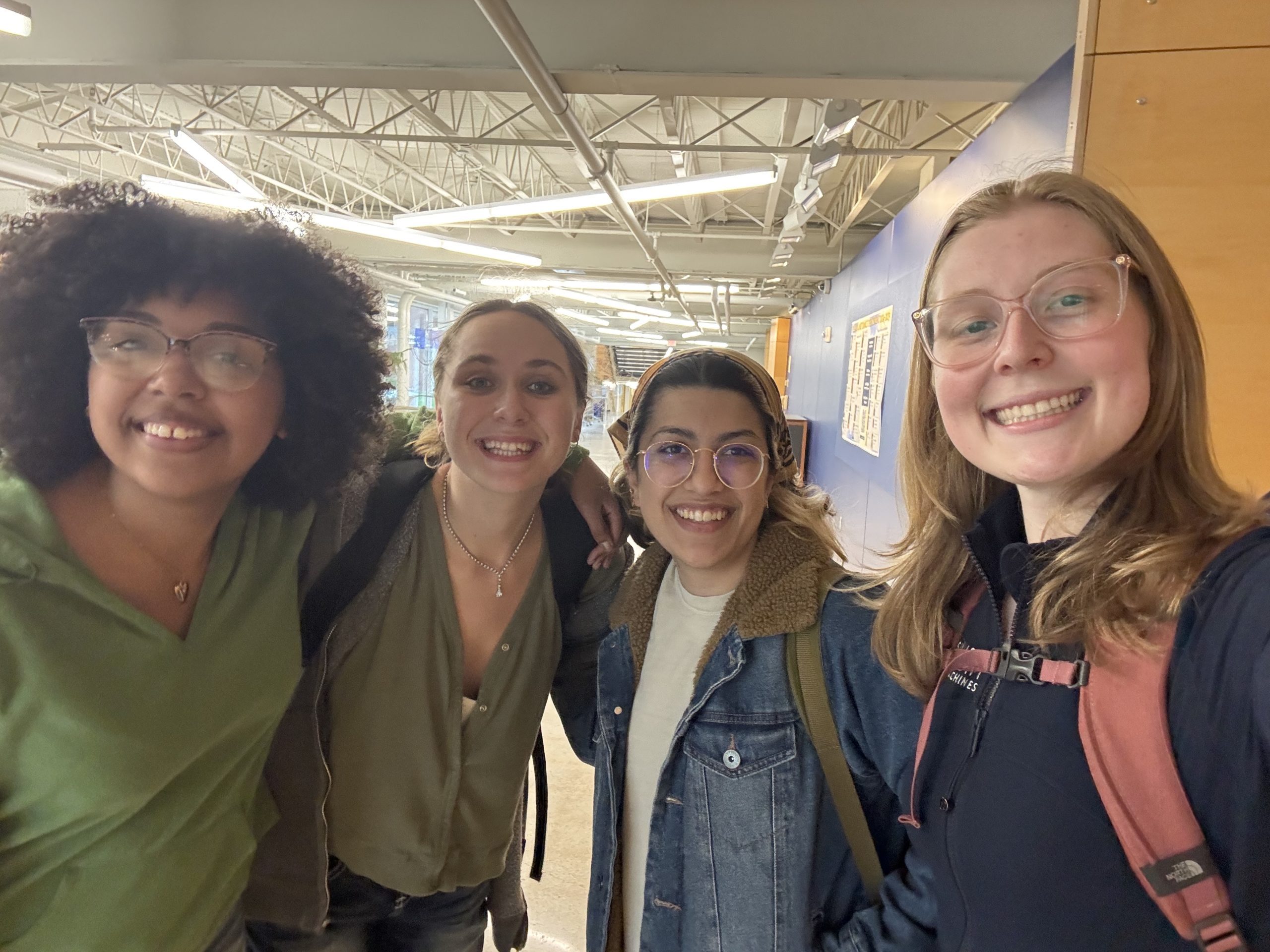 Four students smiling at the camera