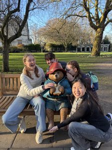 Four students posing in silly ways with Paddington
