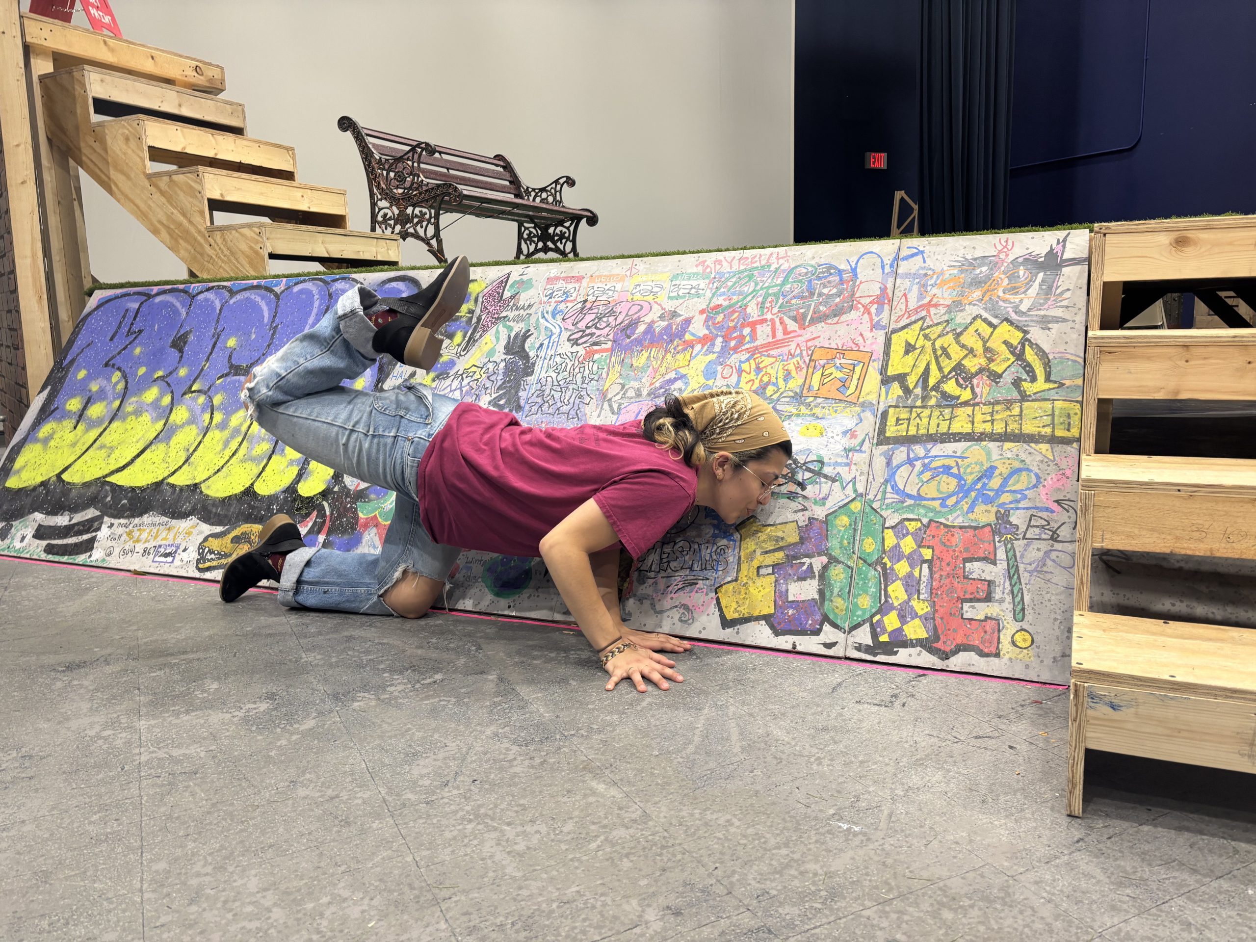 a student posing with the "Feste" graffiti