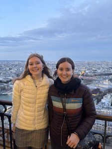 Two girls smiling from the Eiffel Tower