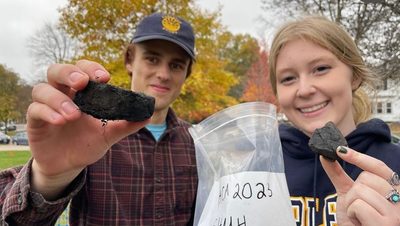 Two Students holding rocks
