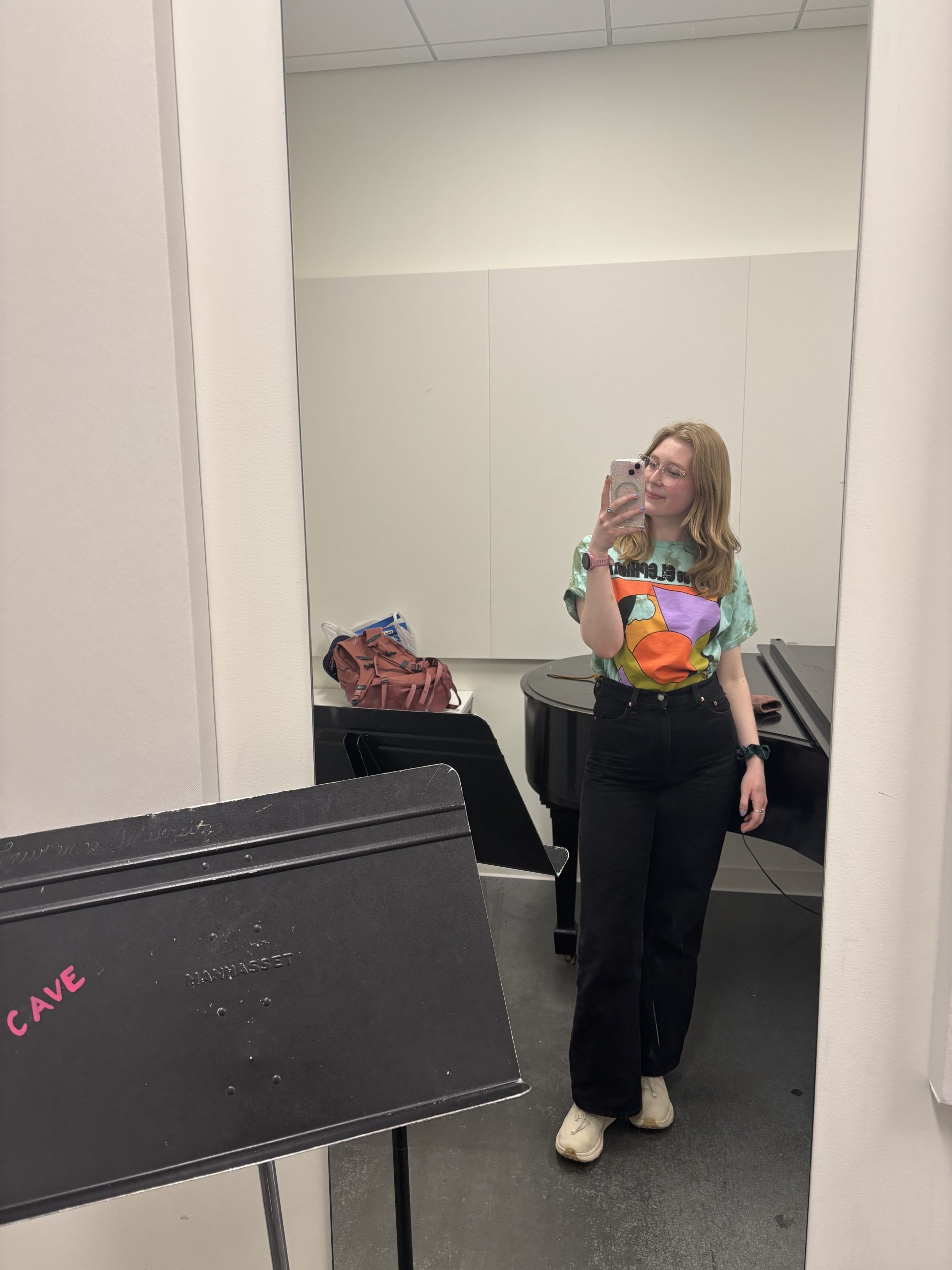A girl in a practice room smiling