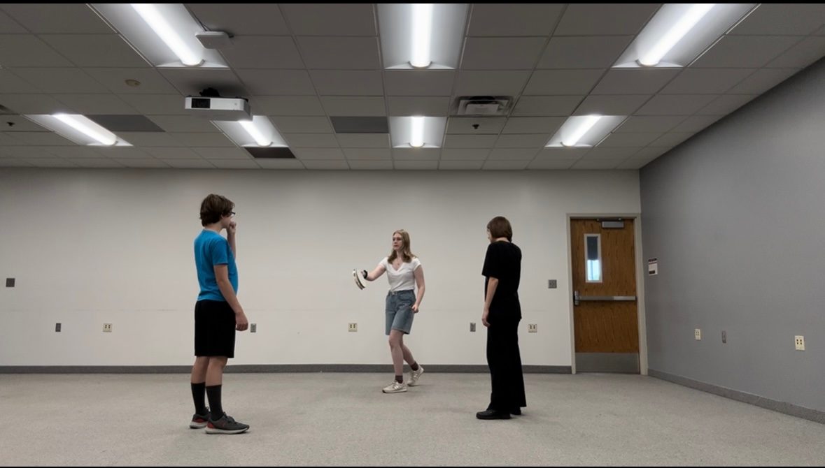 A girl teaching two students