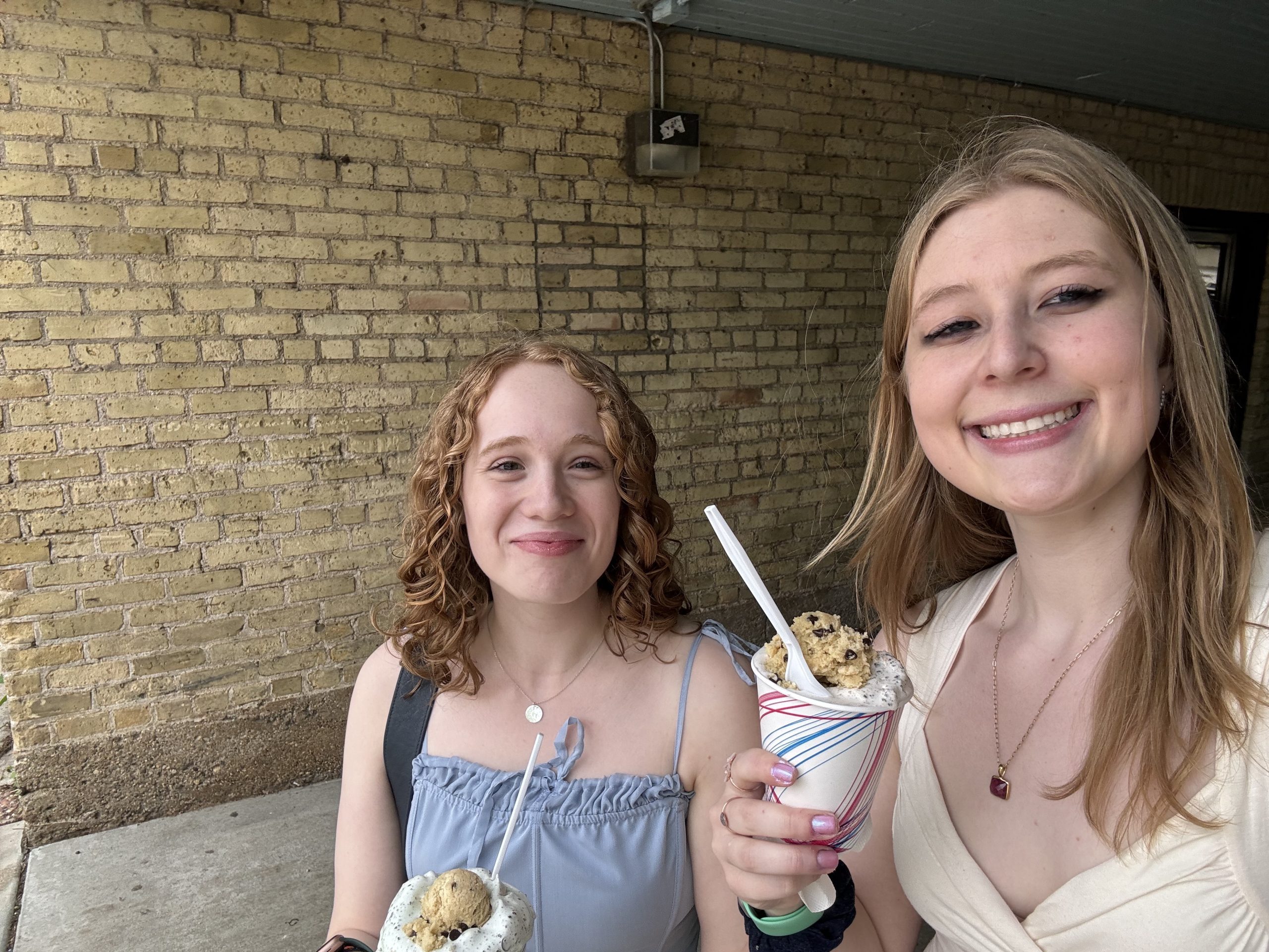 two girls smiling with ice cream