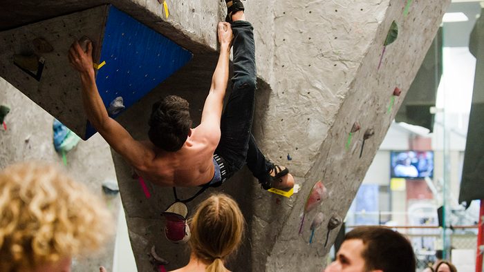 A student climbs a bouldering wall
