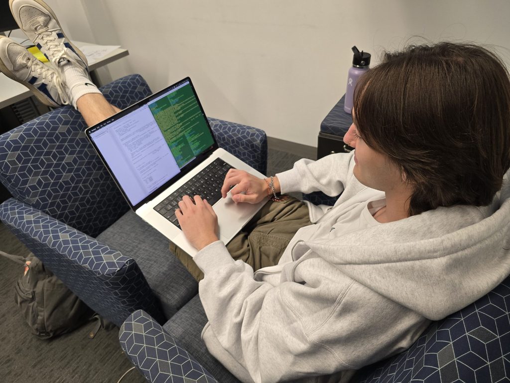 a biology student works on a computational model for evolution