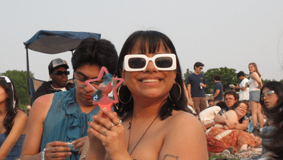 A student posing in a crowd at a music festival