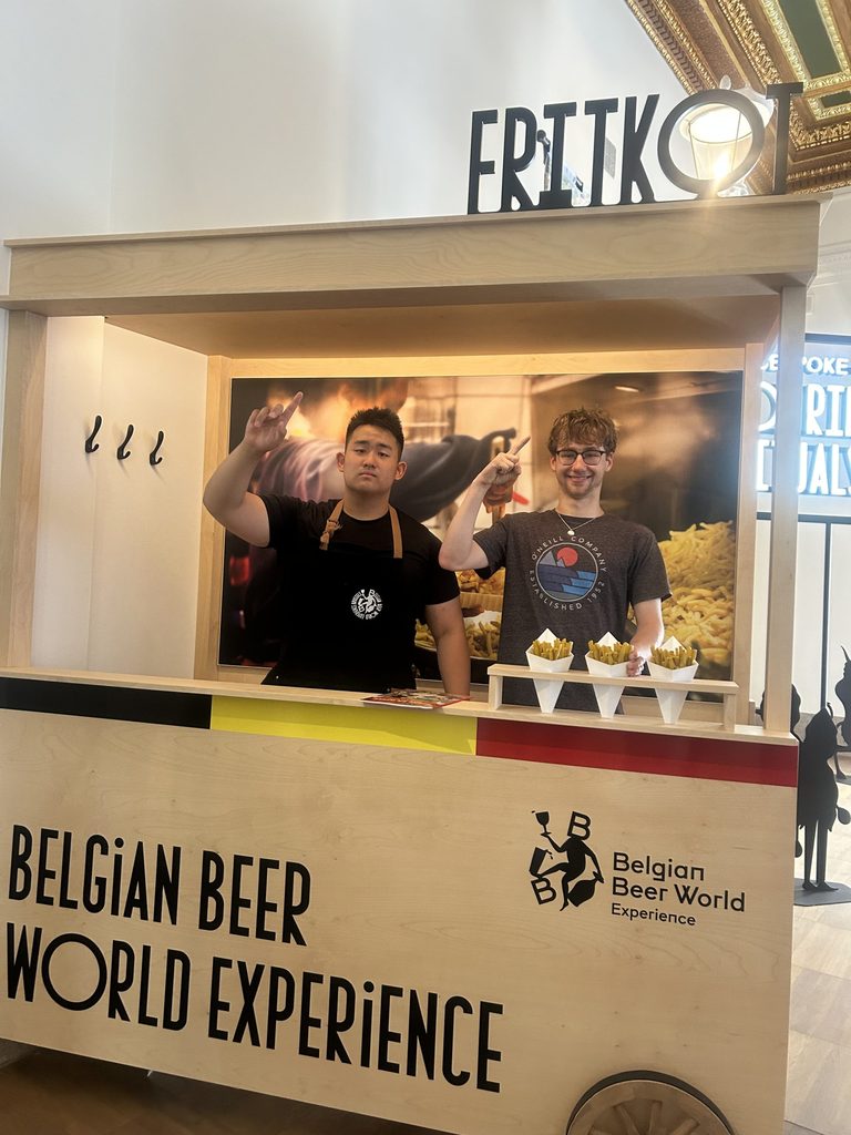 students posing with beer