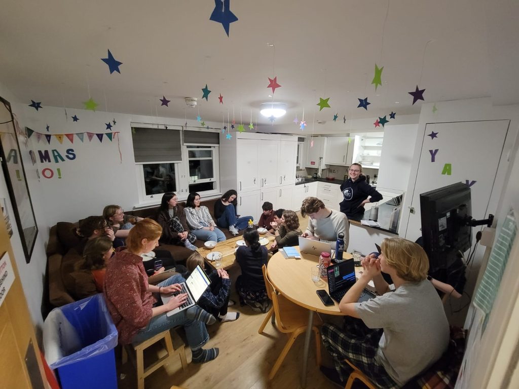 Students hanging out in the common area of a london flat