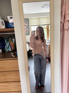 A girl wearing jeans and a top 