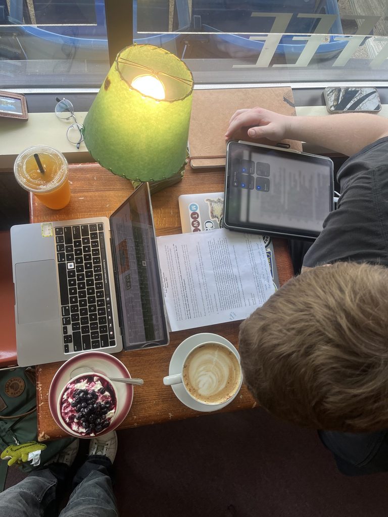 A table at a coffee shop where two students are studying