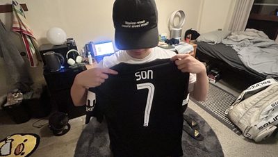 Stefan holding a shirt