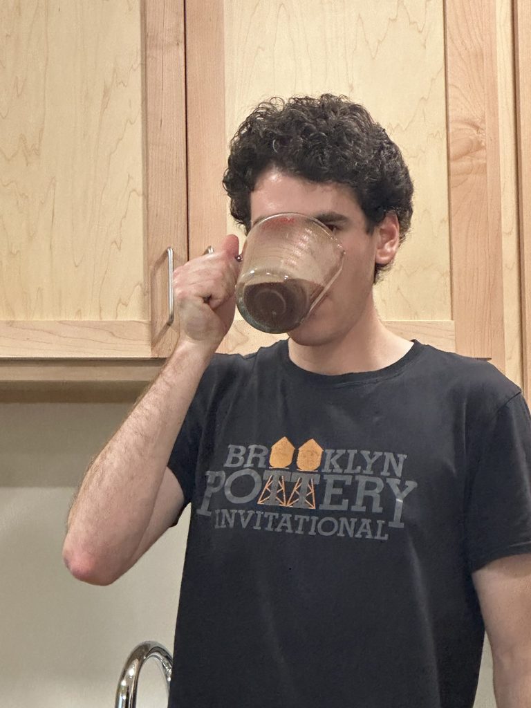 Man drinking his coffee from a beaker