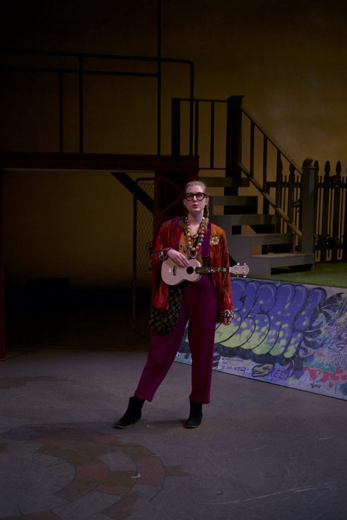 A girl with a ukulele onstage