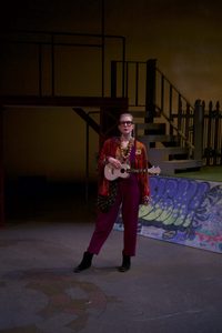 A girl with a ukulele onstage