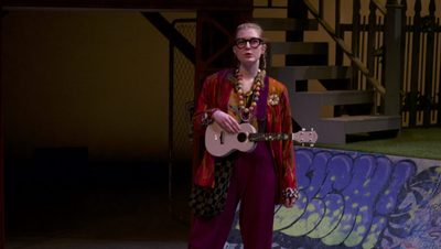 A girl with a ukulele onstage
