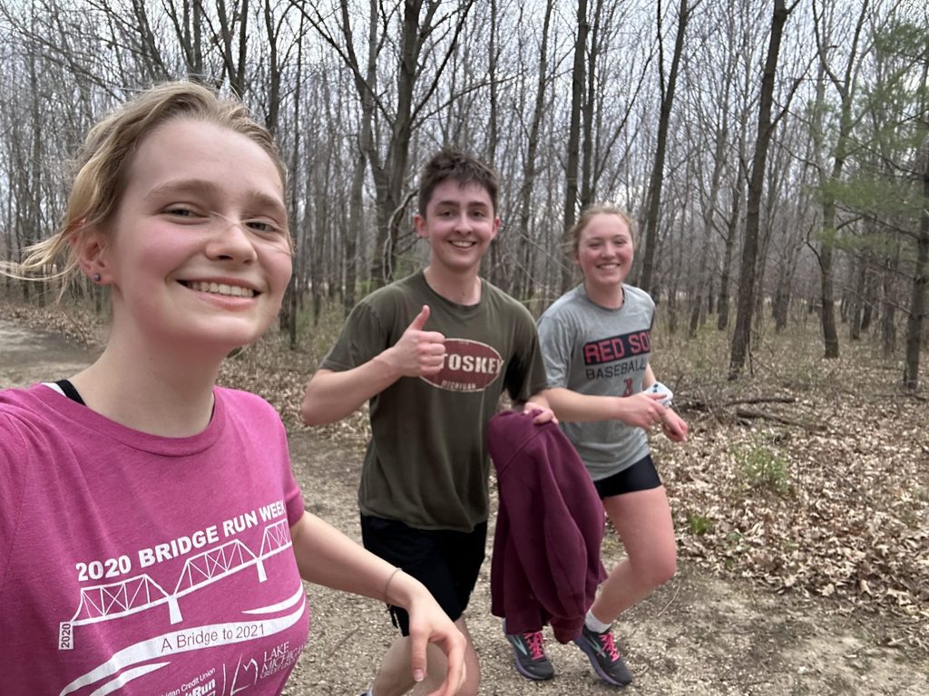 group of students run in the arb