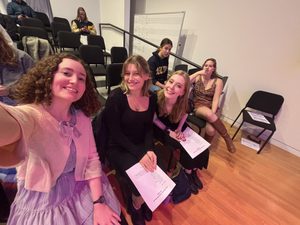 three girls smiling at the camera