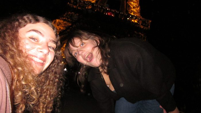 Two girls with the Eiffel Tower in the background.