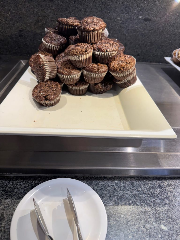 A dozen chocolate muffins on a platter