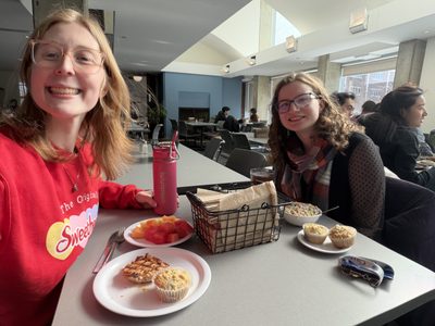 two girls at brunch smiling