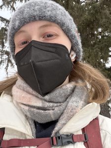 a girl wearing a mask in the snow