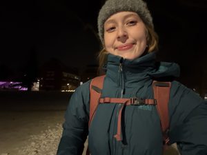 a girl walking in the snow at night