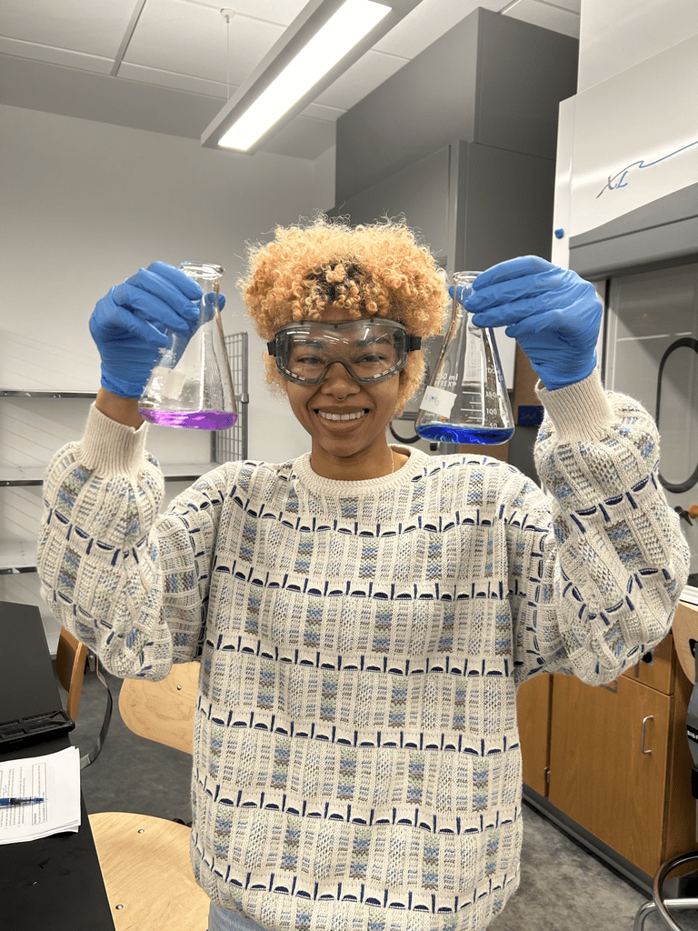 Student holds chemical flasks