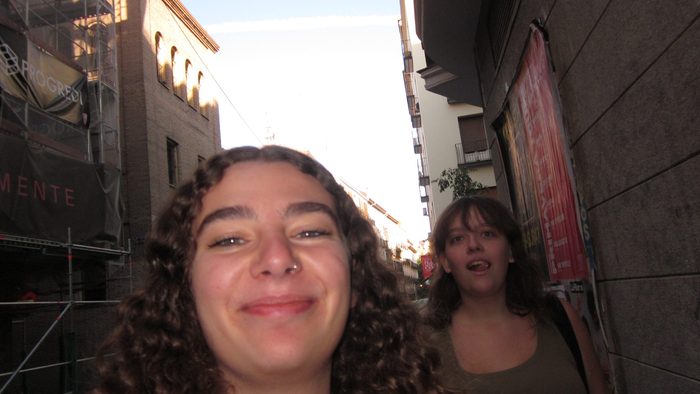 Two people walking down a street