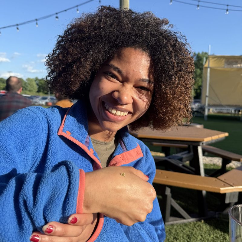 student with inchworm on hand