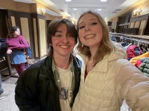two students smiling in the hallway