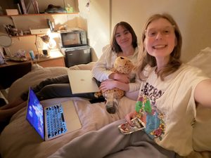 two girls smiling on a bed