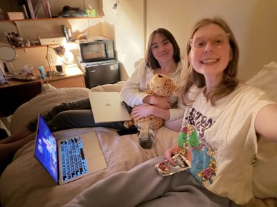 two girls smiling on a bed