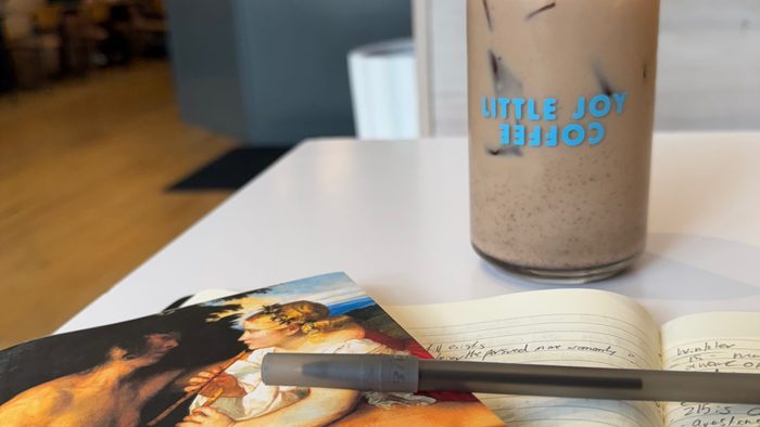 a coffee and book on a table at a cafe