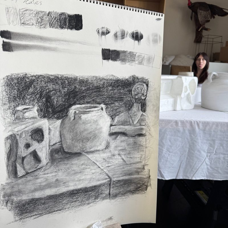 A value drawing still life of several simple objects sitting on a table