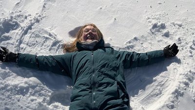 a girl making a snow angel