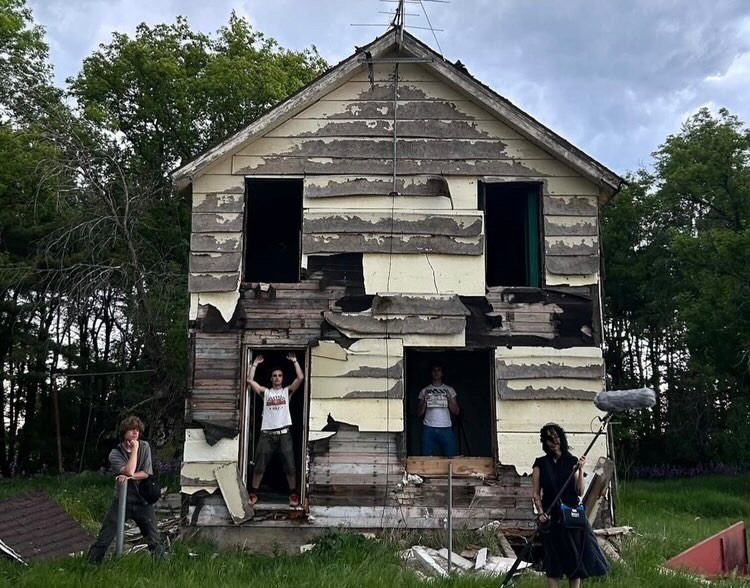 students posing in an old house