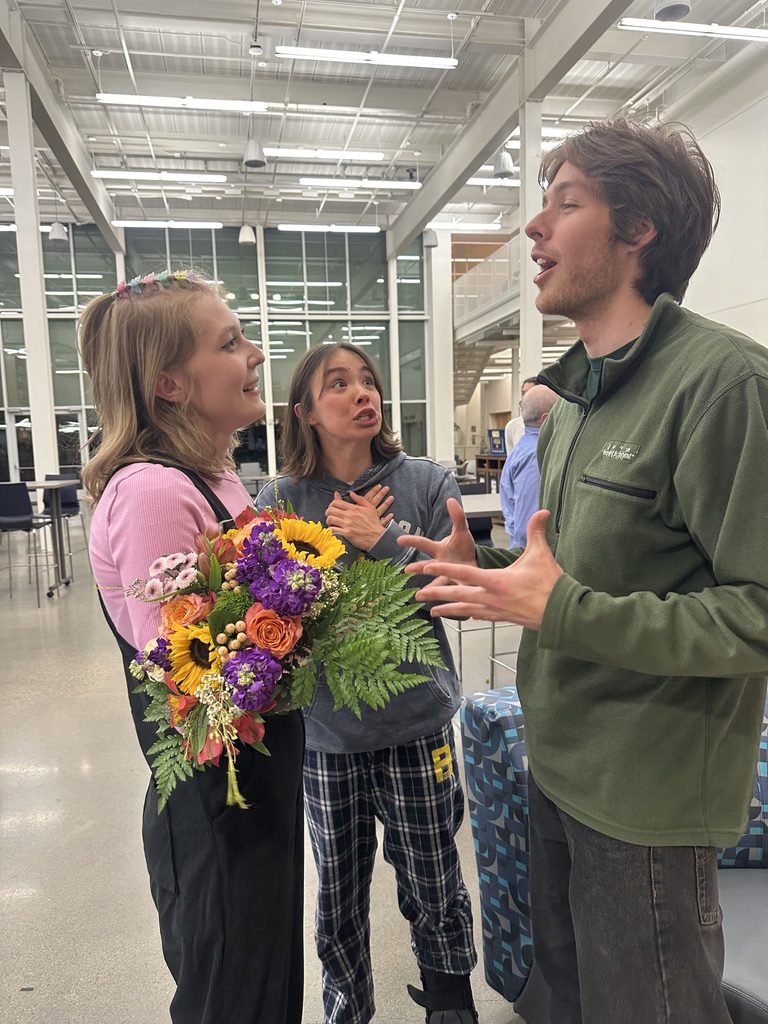 three students talking