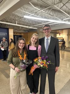 Three students smiling