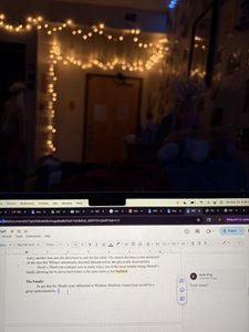 a computer in a dark cozy room 