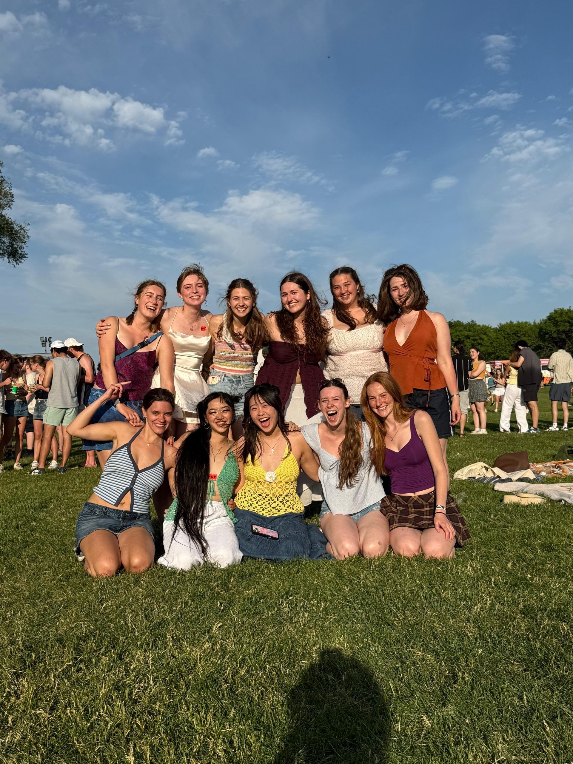 A group of girls smiling and laughing outside.