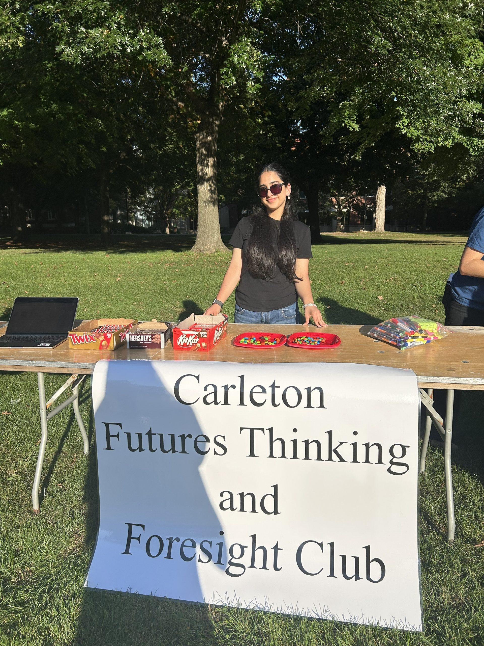 person at table with sign