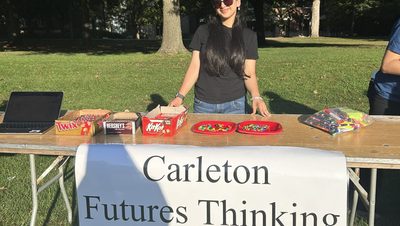 person at table with sign