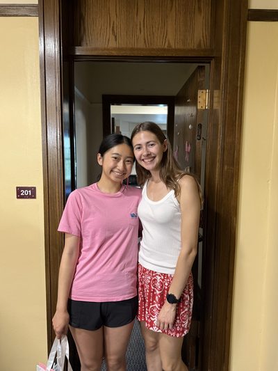 two girls smiling in a doorway