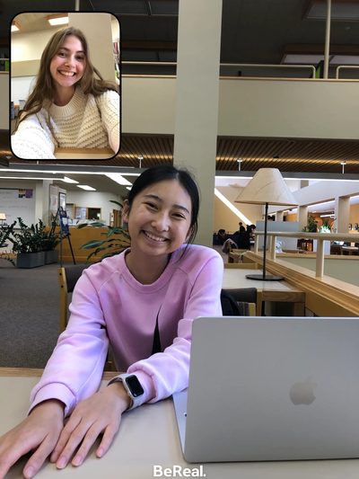 two girls smiling at the library