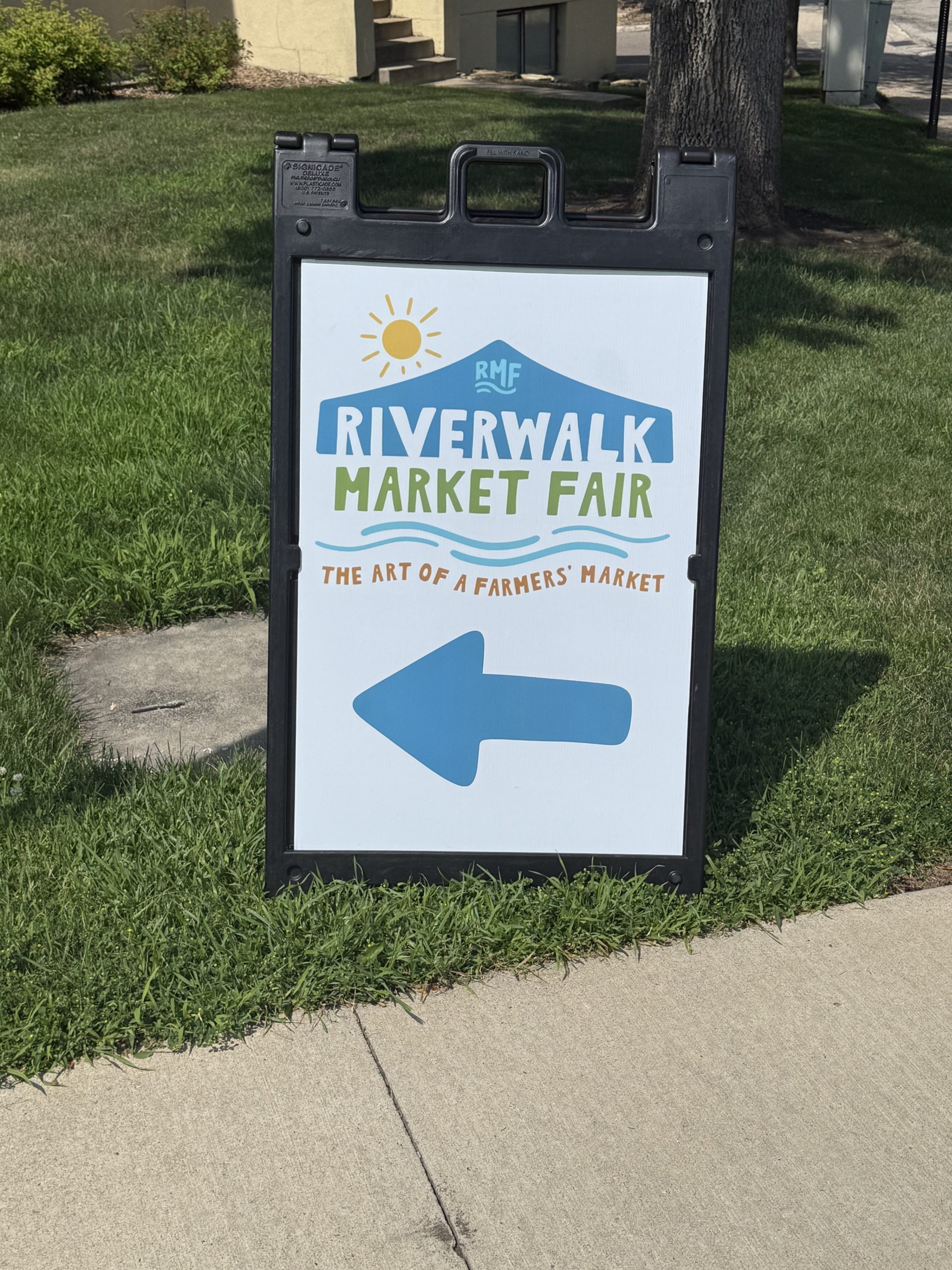The sign of Riverwalk Market Fair